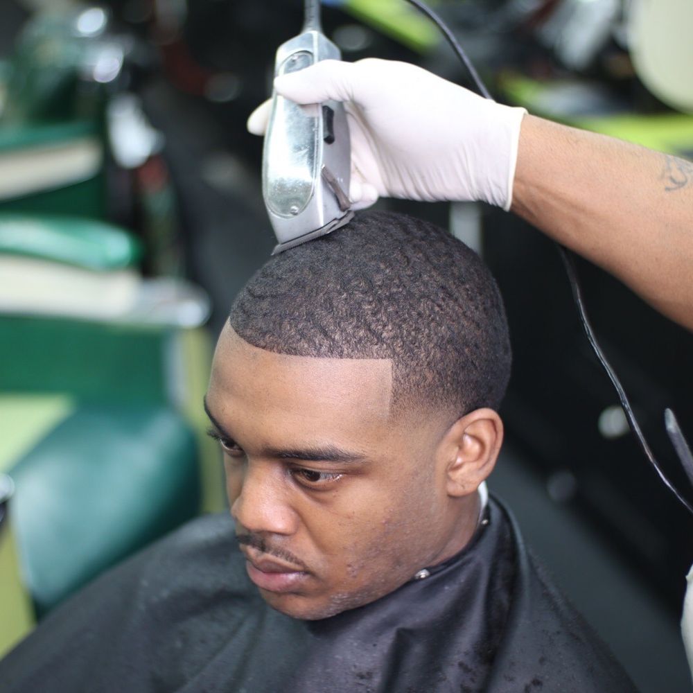 man getting his hair lined up