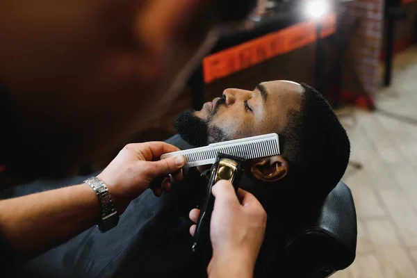 man getting his beard trimmed
